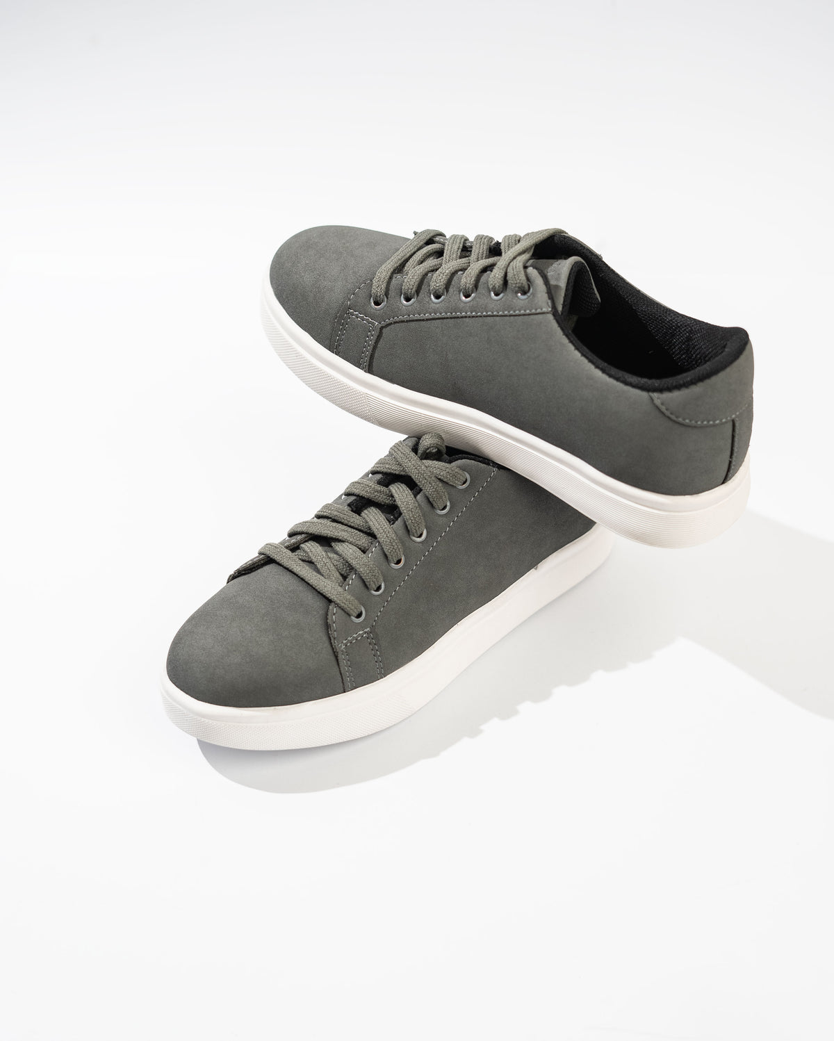 Gray sneakers with white soles on a white background