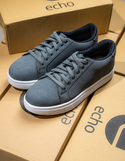Blue sneakers on a cardboard box with 'echo' branding