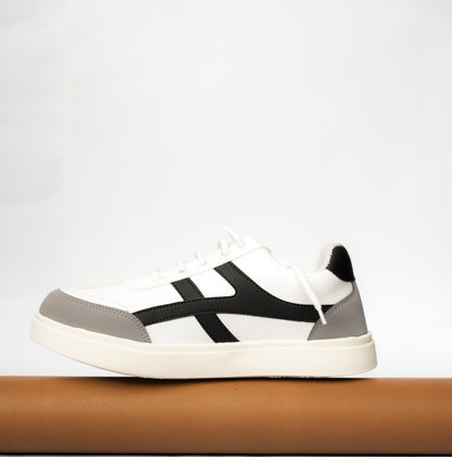 White sneaker with black and gray accents on a light gray background